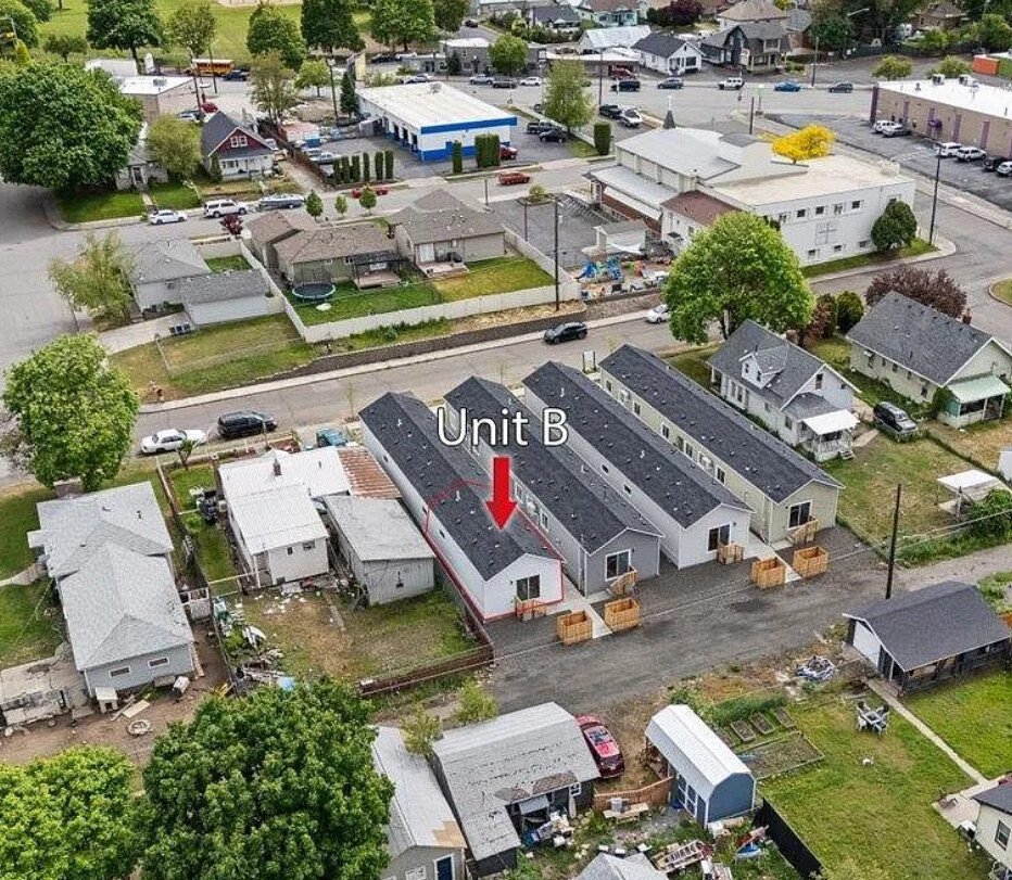 Aerial view of four narrow duplexes fitted into an existing city block